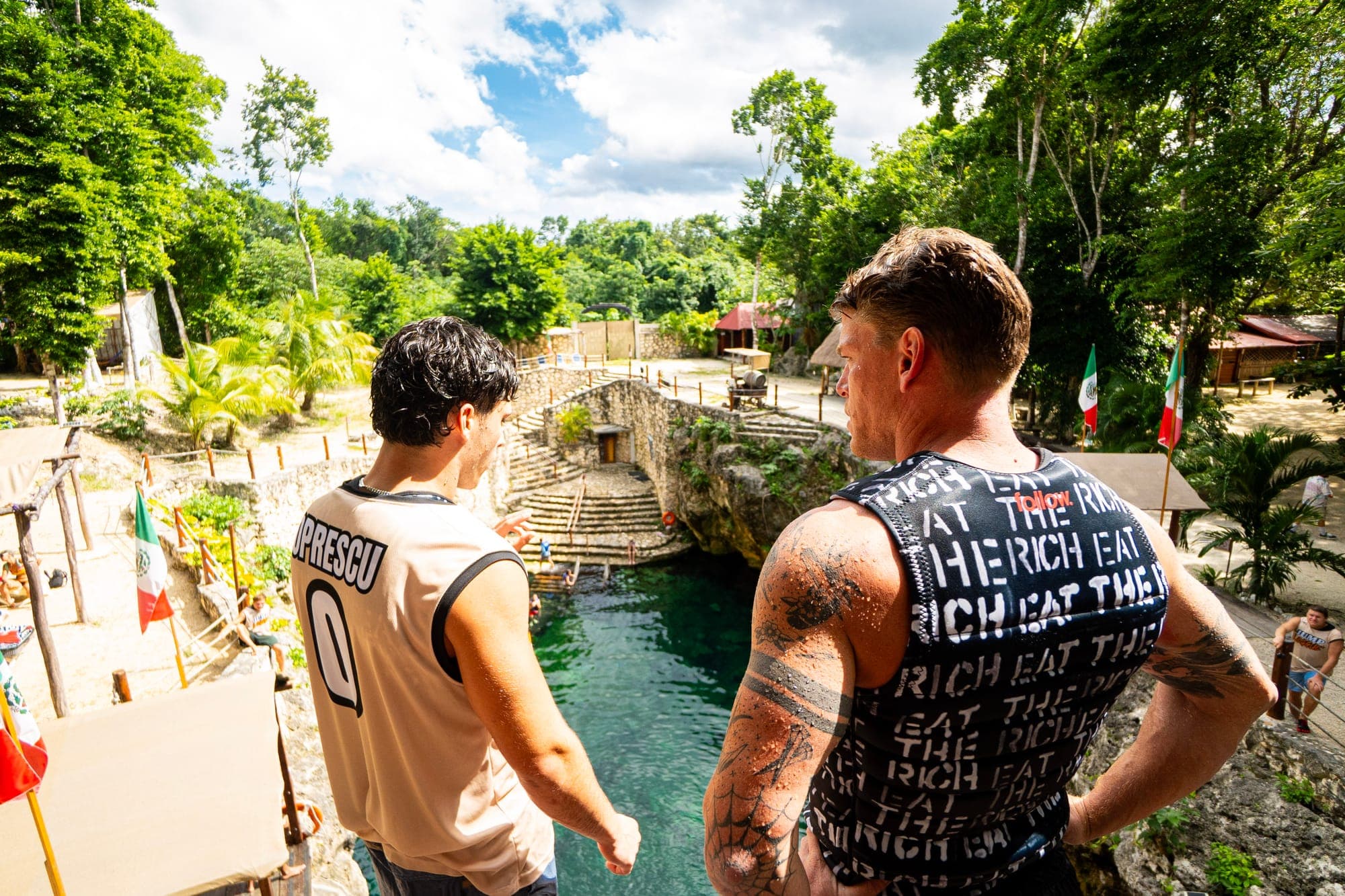 Two Jump League crew members at the edge of the platform, watching the water below